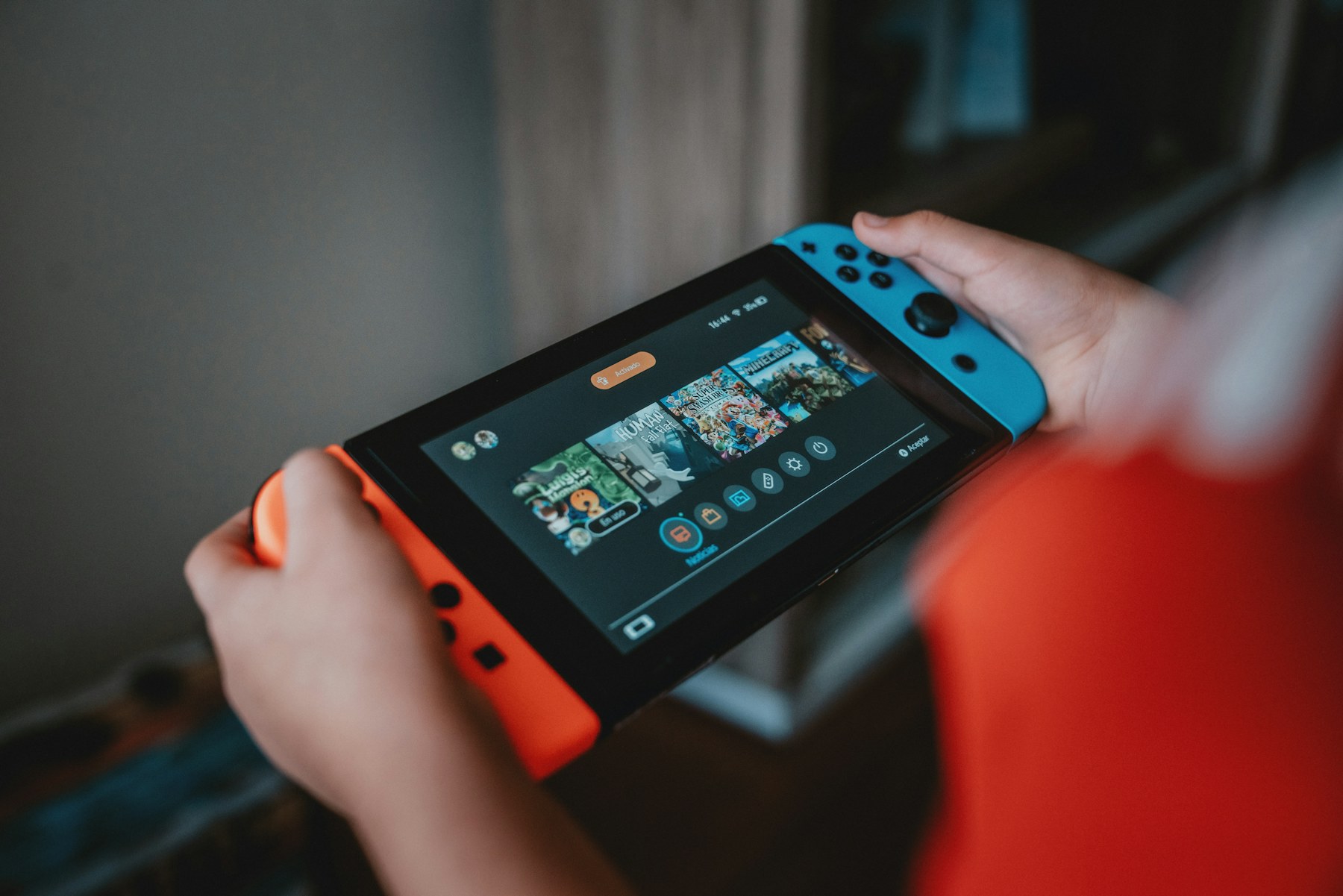 Portable console screen showing a colorful game in handheld mode